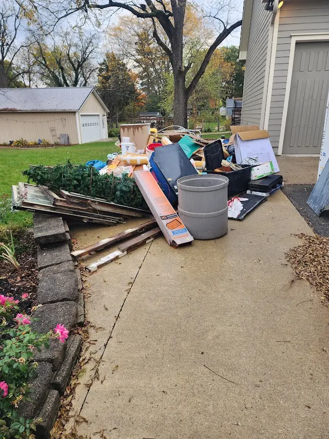Dumpster being loaded with debris for 3 Yard Dumpster Rental in Bunker Hill Village